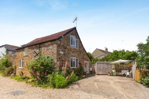 an old brick house with a garden in front of it at 2 Bed in Bridport oc-dc110 in Chideock