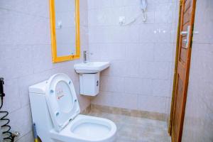 a bathroom with a toilet and a sink at ExtraMile Apartments - 2BR in Dodoma +38 photos