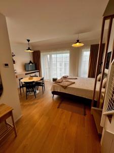 a bedroom with a bed and a dining room at Luxury Gerlach Mountain Mezonet I in Svätý Jur +7 photos