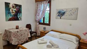 a bedroom with a bed and a table and a window at Sea Breeze Retreat in Lionas +30 photos