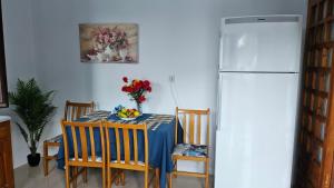 a kitchen with a table and a refrigerator at Sea Breeze Retreat in Lionas