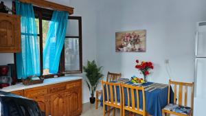 a dining room with a table and chairs and a window at Sea Breeze Retreat in Lionas