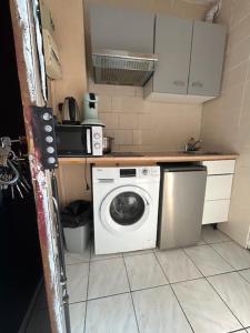 a kitchen with a washing machine in a kitchen at myappart - colombes in Colombes +17 photos