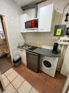 a small kitchen with a sink and a washing machine at myappart - colombes in Colombes