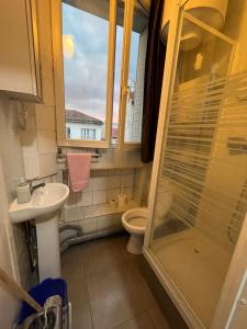 a bathroom with a shower and a toilet and a sink at myappart - colombes in Colombes
