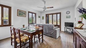 a living room with a table and a couch at Casa Il Pino in Cavriglia
