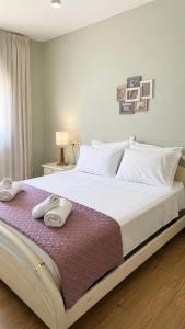 a bedroom with a large bed with towels on it at Seaside Serenity Kefalos in Kefalos