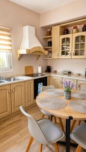 a kitchen with a table and chairs and a sink at Seaside Serenity Kefalos in Kefalos