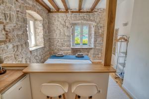 a room with a bed and two chairs at Stunning Views & Hidden Terraces Above the Old Town in Kotor +118 photos