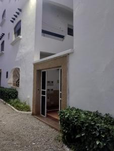 a white building with a door in front of it at Appartement à oued laou mekkad in Oued Laou