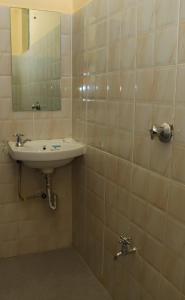 a bathroom with a sink and a mirror at Magik Haven Studios Nyeri in Nyeri