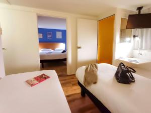 a hotel room with two beds and a bathroom at greet Hotel Belleville en Beaujolais A6 in Belleville-sur-Saône