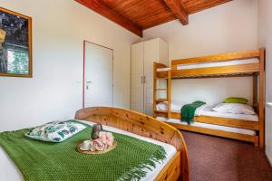 a bedroom with a bed and two bunk beds at Velvet Lipno in Lipno nad Vltavou
