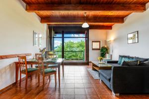a living room with a table and a couch at Velvet Lipno in Lipno nad Vltavou
