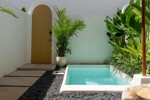 a swimming pool in a courtyard with plants at Villa Drift, Balangan 1BR Surf Getaway in Bingin Beach