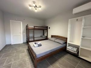 a bedroom with a bunk bed and a tiled floor at MANGO hotel in Zatoka