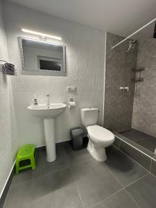 a bathroom with a sink and a toilet and a shower at MANGO hotel in Zatoka