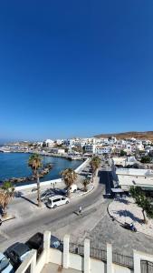 arial view of a parking lot with palm trees and the ocean at Hotel Lito in Tinos