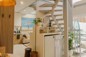 a kitchen and living room with a spiral staircase at Villa Drift, Balangan 1BR Surf Getaway in Bingin Beach