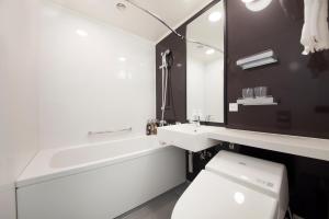 uma casa de banho com uma banheira, um WC e um lavatório. em Richmond Hotel Tokyo Suidobashi em Tóquio