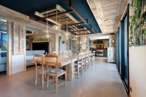 a dining room with a long table and chairs at Lodge Six De Savoie in La Toussuire