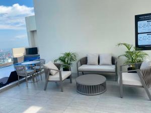 a patio with chairs and tables on a building at MyHappyPlace Elements in Manila +12 photos