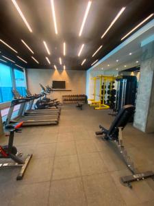 a gym with a row of treadmills and machines at MyHappyPlace Elements in Manila