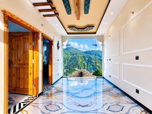an empty hallway with a tile floor and a view at Nathia Gali Top Resort in Nathia Gali +4 photos
