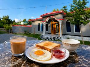 a plate of eggs and toast and a cup of coffee at Nathia Gali Top Resort in Nathia Gali