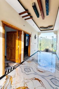 an empty room with a marble floor and a glass door at Nathia Gali Top Resort in Nathia Gali