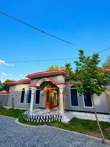 a house with a yellow door and a tree at Nathia Gali Top Resort in Nathia Gali