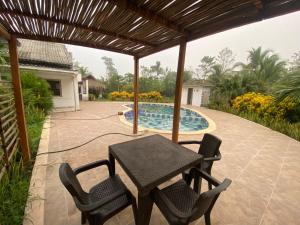 a patio with a table and chairs and a swimming pool at Casa Finca la Parcela in San Onofre