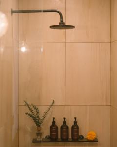 a bathroom with three bottles sitting on a shelf at Villa Drift, Balangan 1BR Surf Getaway in Bingin Beach +16 photos