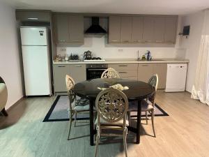 a kitchen with a table and chairs and a refrigerator at Villa Tego in Çeşme