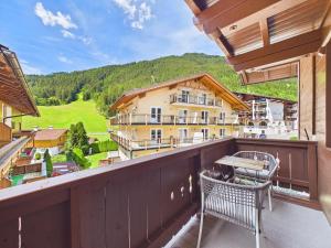 a balcony with a bench and a view of a building at LUMA Stubai Aparthotel - Neueröffnung inklusive STUBAI SUPER CARD in Neustift im Stubaital
