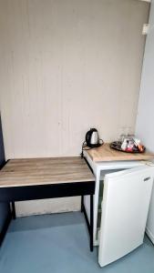 a pair of benches in a room with a refrigerator at Kaleaba House on the Riverside in Parys