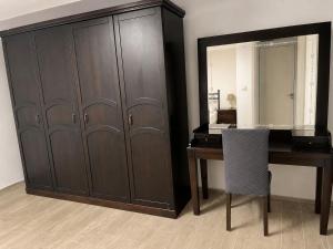 a desk and a cabinet with a table and a chair at Villa Tego in Çeşme +1 photo