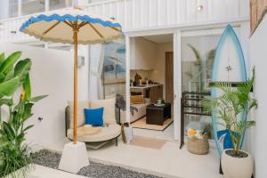 a living room with a surfboard in a room at Villa Drift, Balangan 1BR Surf Getaway in Bingin Beach