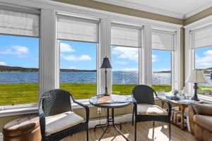 a living room with a view of the water at Westward Oceanfront Sunsets over Trinity Bay in Hearts Delight