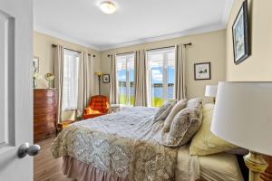 a bedroom with a bed and a window at Westward Oceanfront Sunsets over Trinity Bay in Hearts Delight