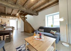 a living room with a blue couch and a table at Xola in Saint-Just-Ibarre