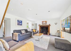 a living room with two couches and a fireplace at Lagnakeil Highland Lodges in Oban