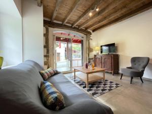 a living room with a couch and a table at Xola in Saint-Just-Ibarre