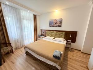 a bedroom with a large bed in a room at Mini Hotel "Arystan" в самом центре столицы in Astana