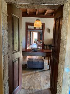an open door into a living room with a table at Manor House Dungeon in Chozendo +22 photos
