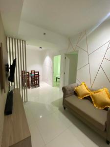 a living room with a couch and a dining room at MyHappyPlace Elements in Manila