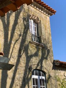 a shadow of a building with a window and a balcony at Manor House Dungeon in Chozendo