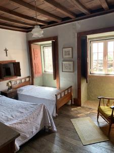 a bedroom with two beds and a cross on the wall at Manor House Dungeon in Chozendo