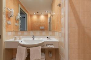 a bathroom with a sink and a mirror at Hotel Rivalago in Sulzano