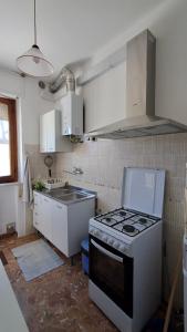 a kitchen with a stove top oven in a kitchen at Casa Panorama in Senigallia